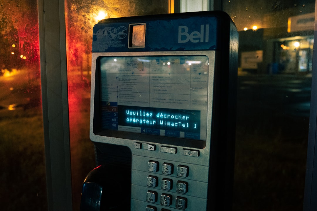 A cell phone sitting next to a window at night