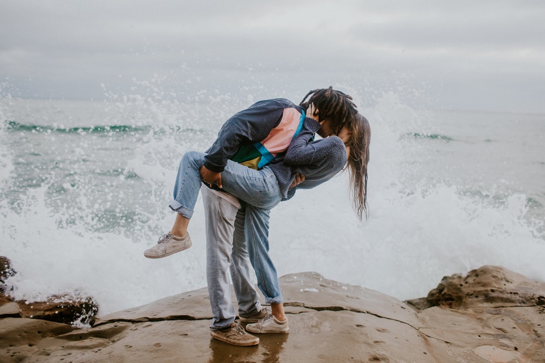 man hugging woman during daytime